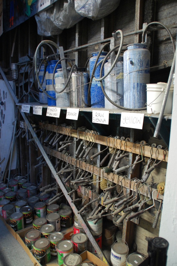 Paint rack with Hudson sprayers and roller mandles